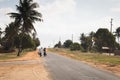 African couple carrying goods at the side of the road in Tofo